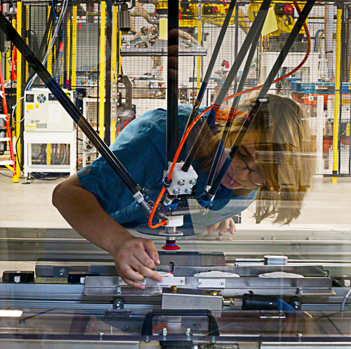 technician adjusting pick & place robot