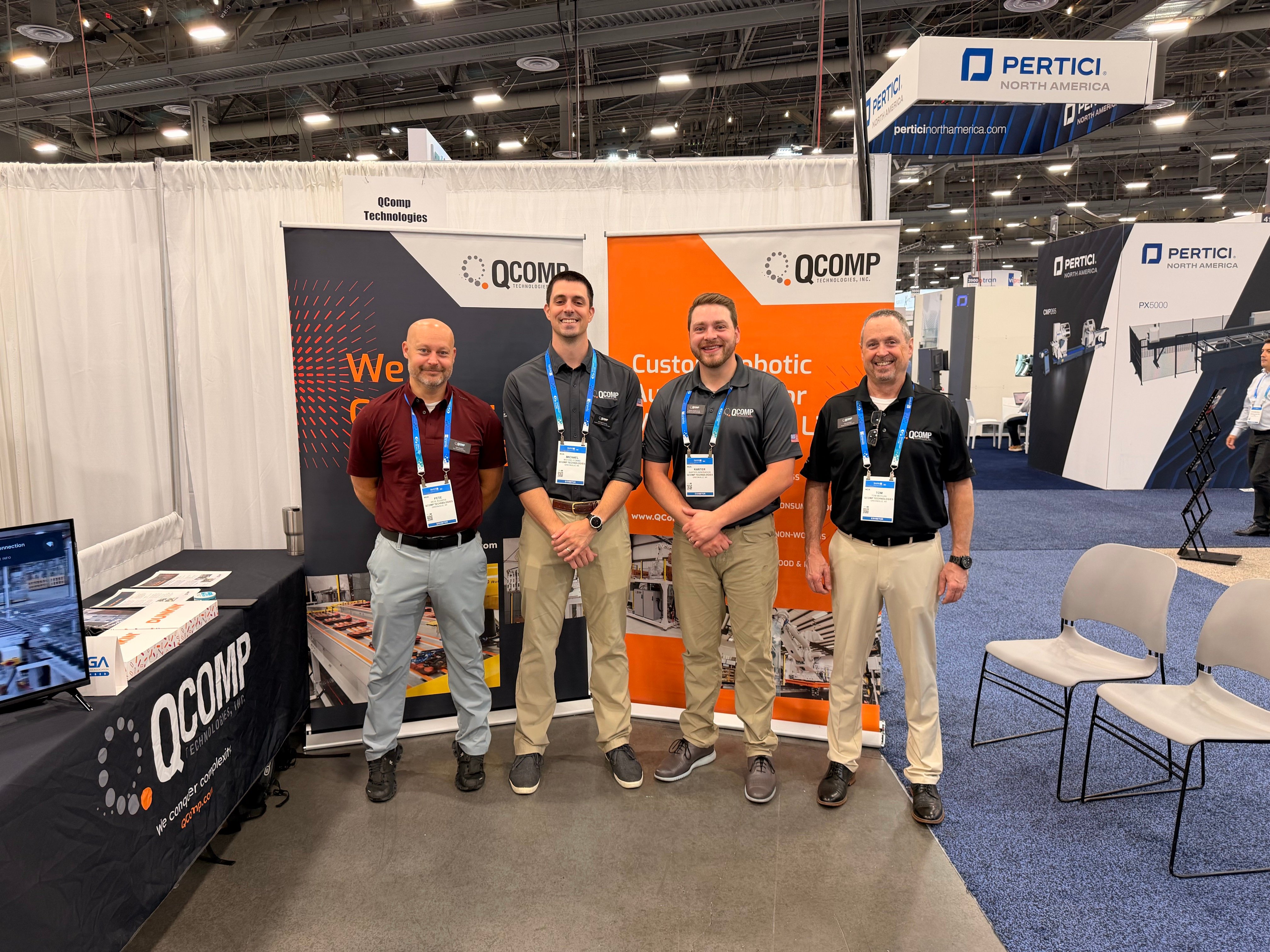 4 qcomp employees at tradeshow