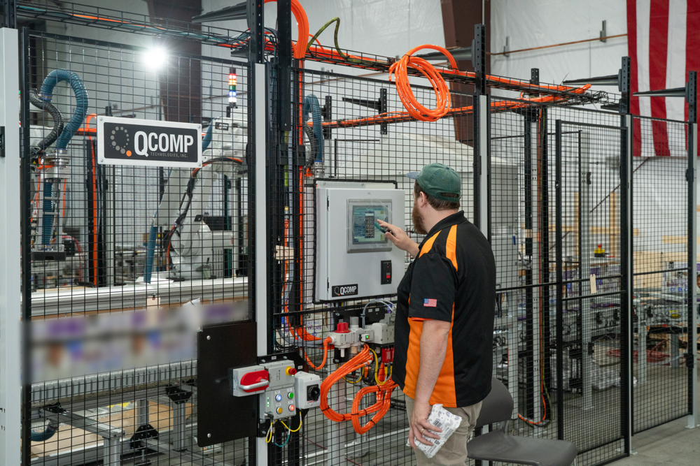 QComp Employee Programming a Robot